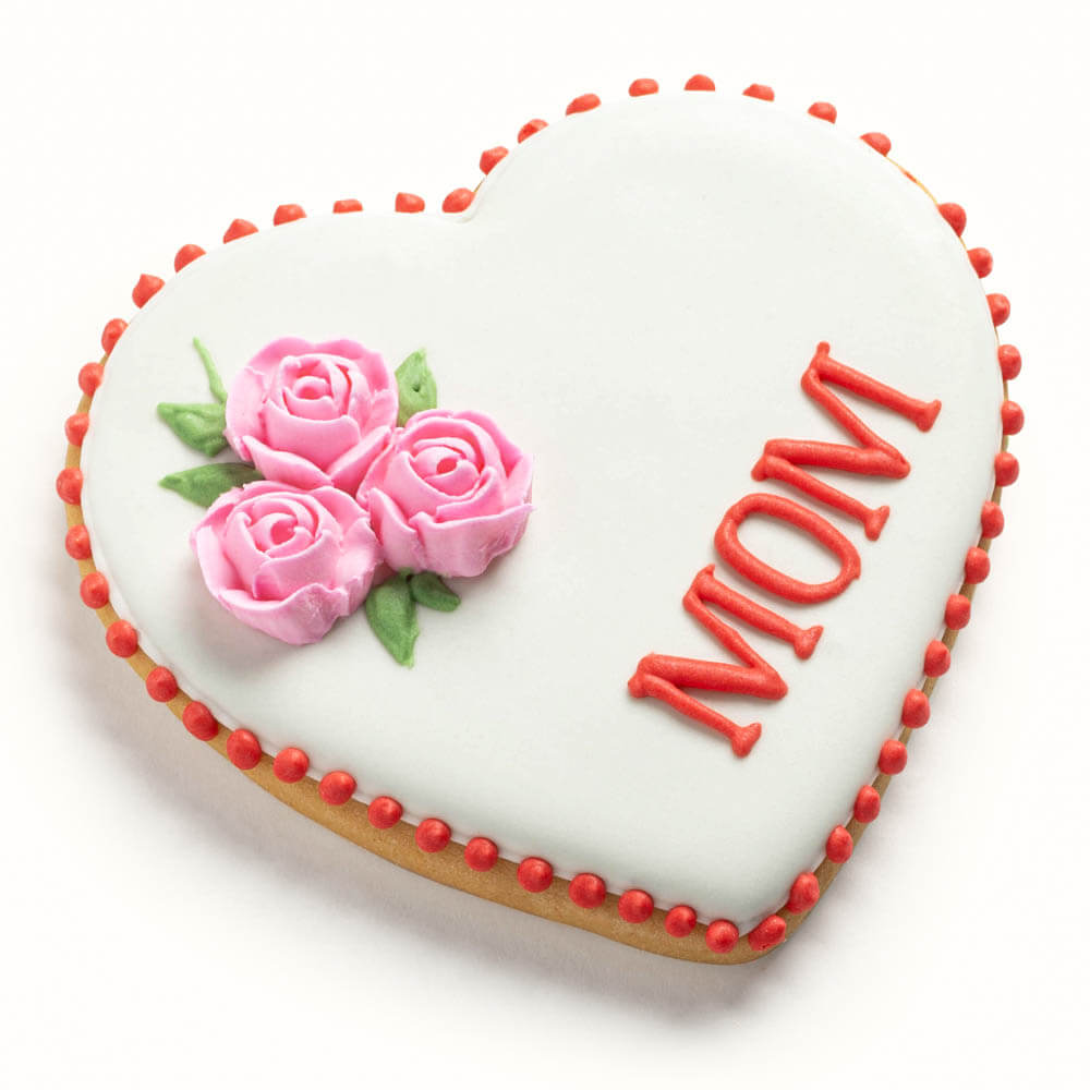 Heart-shaped sugar cookie for Mother's Day featuring hand-piped pink icing roses and a personalized name or message.