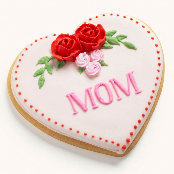 Heart-shaped sugar cookie for Mother's Day featuring hand-piped pink icing roses and a personalized name or message.