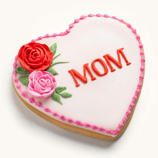 Heart-shaped sugar cookie for Mother's Day featuring hand-piped pink icing roses and a personalized name or message.