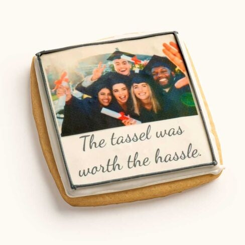 Customizable square sugar cookie featuring a printed personal graduation photo and custom text with hand-piped icing border