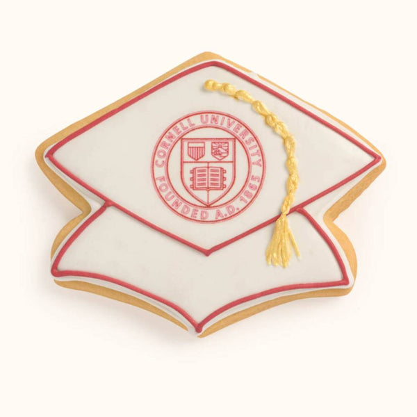 Customizable graduation cap cookie featuring printed school logo and hand-piped tassel in team colors.